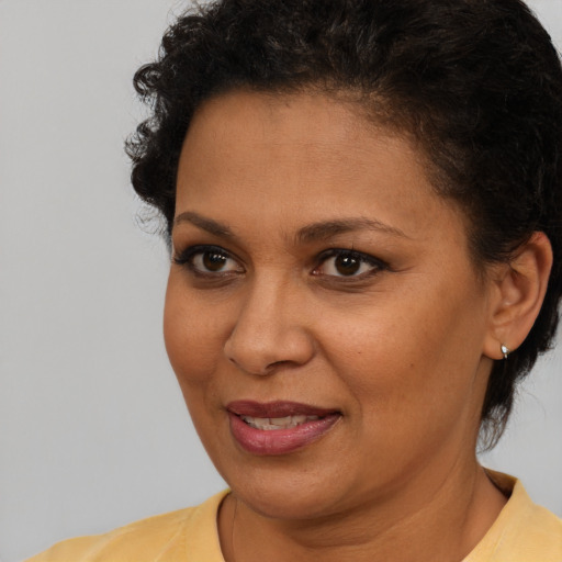 Joyful latino adult female with short  brown hair and brown eyes