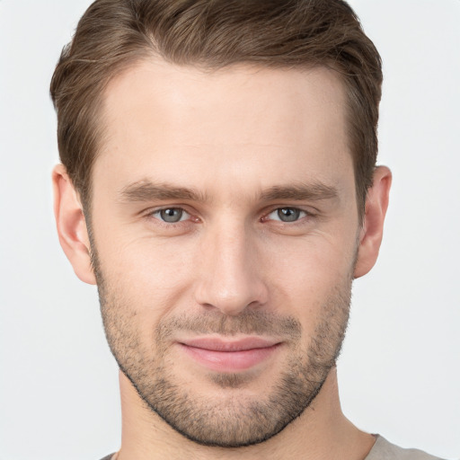 Joyful white young-adult male with short  brown hair and grey eyes