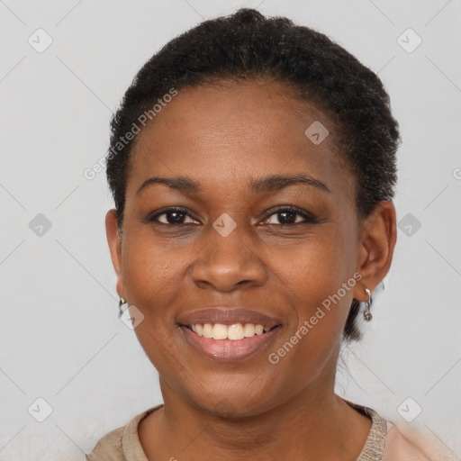 Joyful black young-adult female with short  brown hair and brown eyes