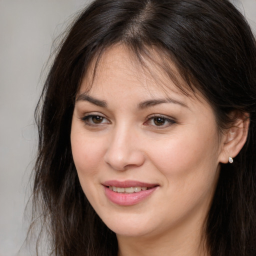 Joyful white young-adult female with long  brown hair and brown eyes