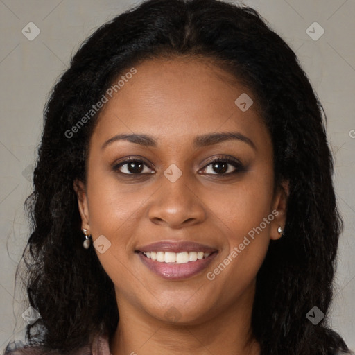 Joyful black young-adult female with long  brown hair and brown eyes