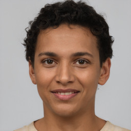 Joyful latino young-adult male with short  brown hair and brown eyes