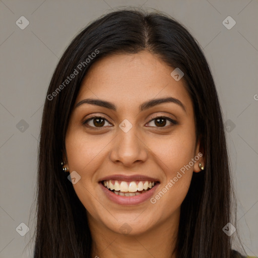 Joyful latino young-adult female with long  brown hair and brown eyes