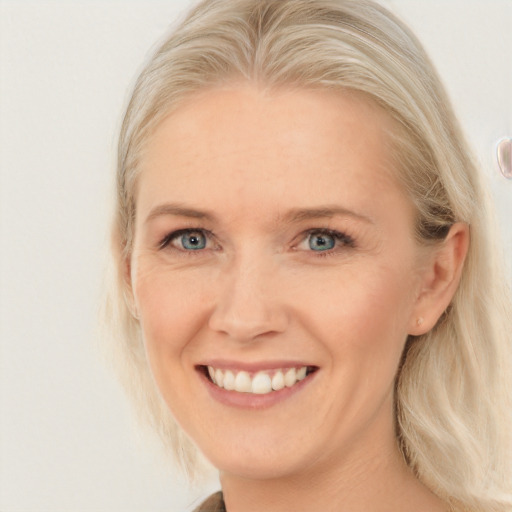 Joyful white young-adult female with medium  blond hair and blue eyes