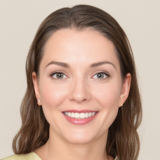 Joyful white young-adult female with medium  brown hair and grey eyes