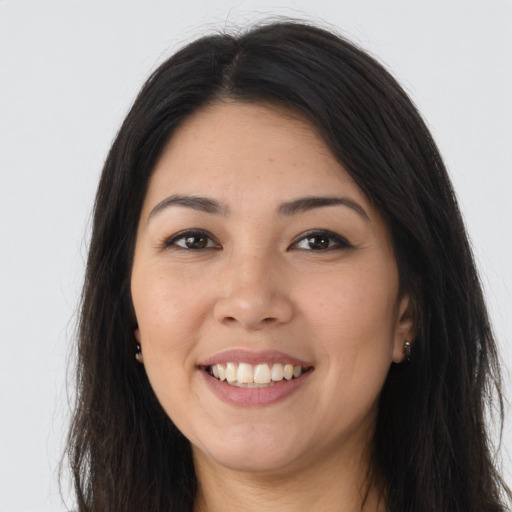 Joyful asian young-adult female with long  brown hair and brown eyes