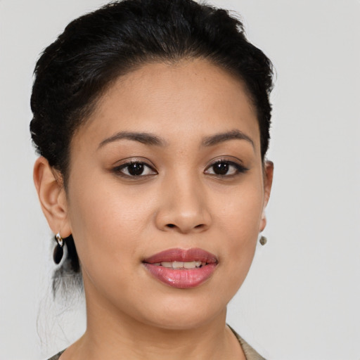 Joyful latino young-adult female with short  brown hair and brown eyes