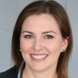 Joyful white young-adult female with medium  brown hair and blue eyes