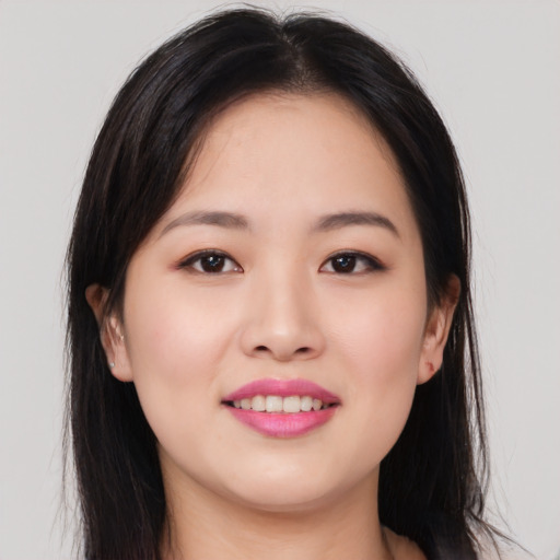 Joyful asian young-adult female with long  brown hair and brown eyes
