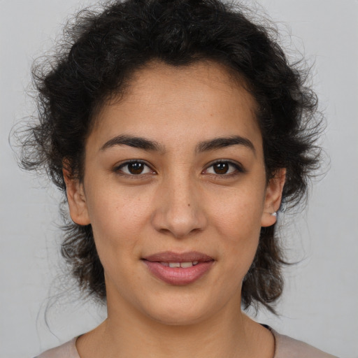 Joyful latino young-adult female with medium  brown hair and brown eyes