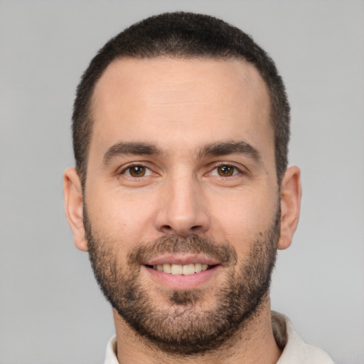 Joyful white young-adult male with short  brown hair and brown eyes