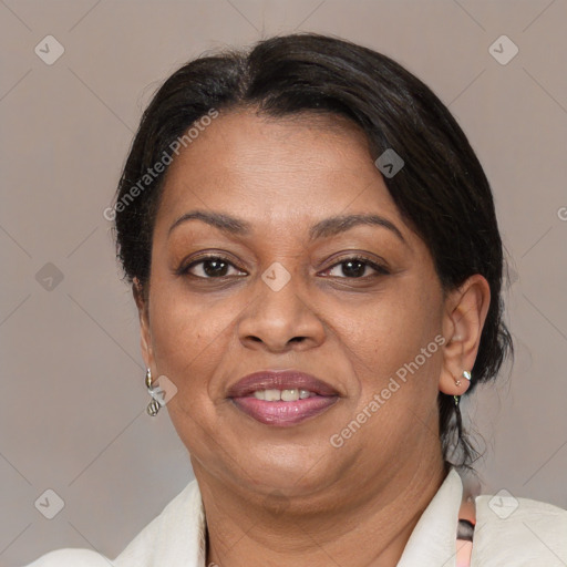 Joyful black adult female with medium  brown hair and brown eyes