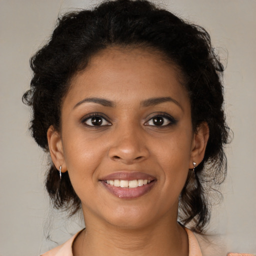 Joyful black young-adult female with medium  brown hair and brown eyes