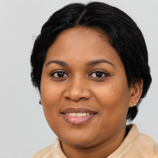 Joyful latino adult female with medium  black hair and brown eyes