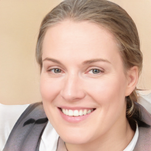 Joyful white young-adult female with medium  brown hair and blue eyes