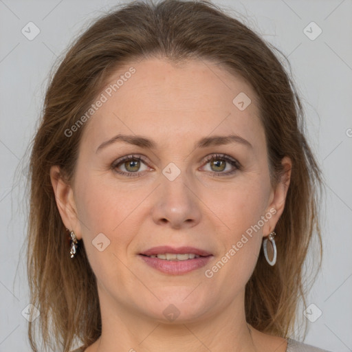 Joyful white adult female with medium  brown hair and grey eyes