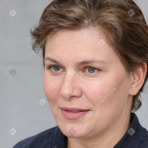 Joyful white adult female with medium  brown hair and blue eyes