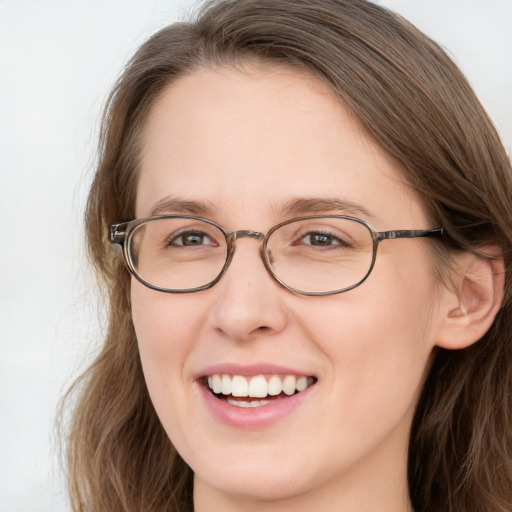 Joyful white young-adult female with long  brown hair and blue eyes