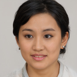 Joyful asian young-adult female with medium  brown hair and brown eyes