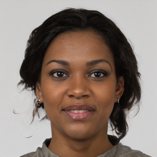 Joyful black young-adult female with medium  black hair and brown eyes