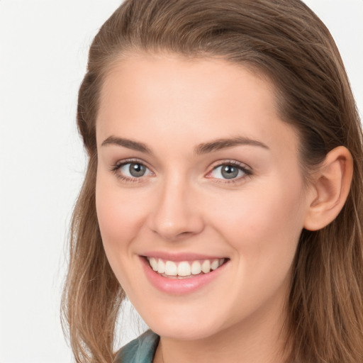 Joyful white young-adult female with long  brown hair and grey eyes