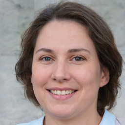 Joyful white adult female with medium  brown hair and brown eyes