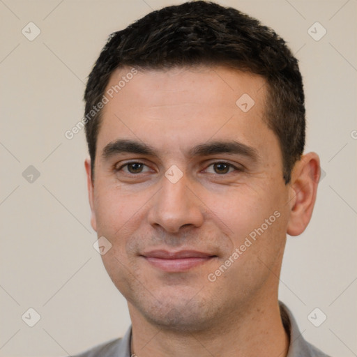 Joyful white young-adult male with short  black hair and brown eyes