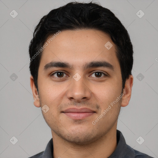 Joyful latino young-adult male with short  black hair and brown eyes