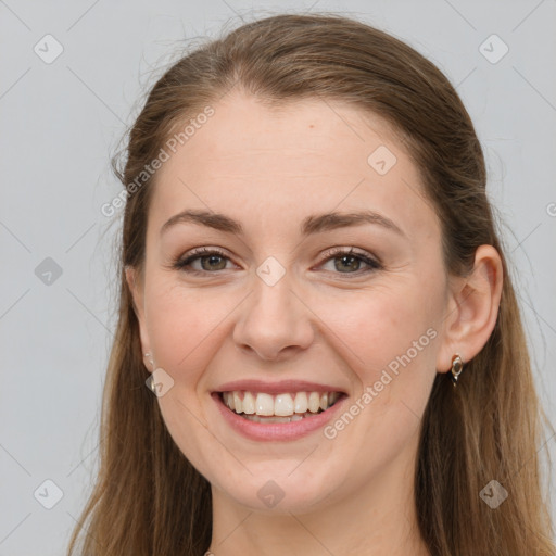 Joyful white young-adult female with long  brown hair and grey eyes