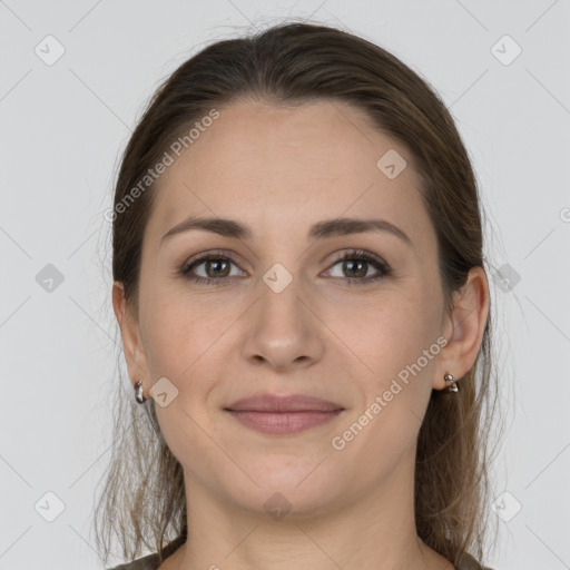 Joyful white young-adult female with medium  brown hair and grey eyes