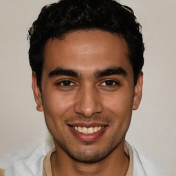 Joyful white young-adult male with short  black hair and brown eyes