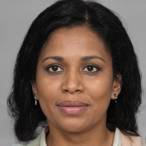 Joyful black adult female with medium  black hair and brown eyes