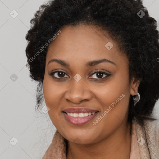 Joyful black young-adult female with long  brown hair and brown eyes