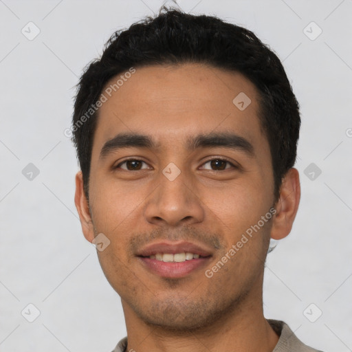 Joyful latino young-adult male with short  black hair and brown eyes