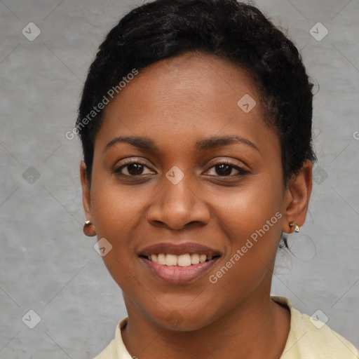 Joyful black young-adult female with short  black hair and brown eyes