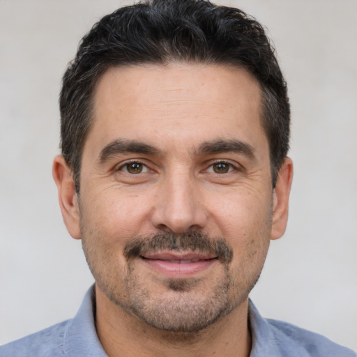 Joyful white adult male with short  brown hair and brown eyes