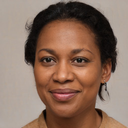 Joyful black adult female with medium  brown hair and brown eyes