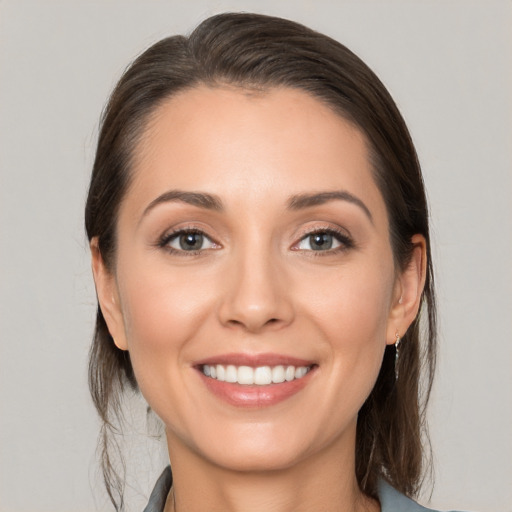 Joyful white young-adult female with medium  brown hair and brown eyes