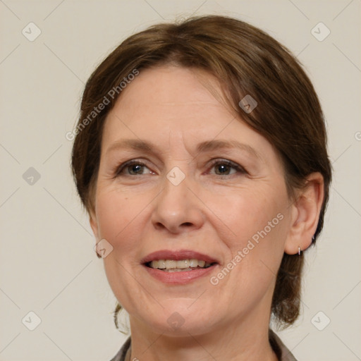 Joyful white adult female with medium  brown hair and grey eyes