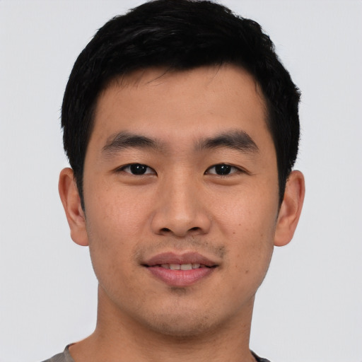 Joyful asian young-adult male with short  black hair and brown eyes