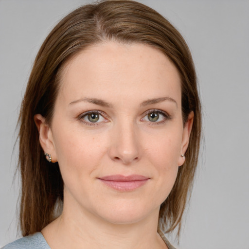 Joyful white young-adult female with medium  brown hair and blue eyes