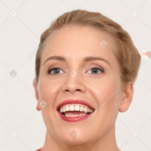 Joyful white young-adult female with short  brown hair and blue eyes