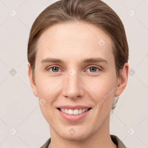 Joyful white young-adult female with short  brown hair and grey eyes