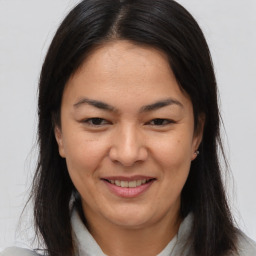 Joyful asian young-adult female with long  brown hair and brown eyes