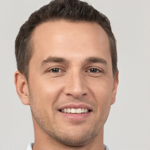 Joyful white young-adult male with short  brown hair and brown eyes