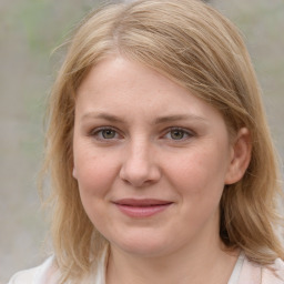 Joyful white young-adult female with medium  brown hair and blue eyes