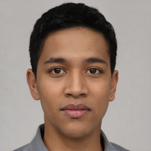 Joyful latino young-adult male with short  black hair and brown eyes