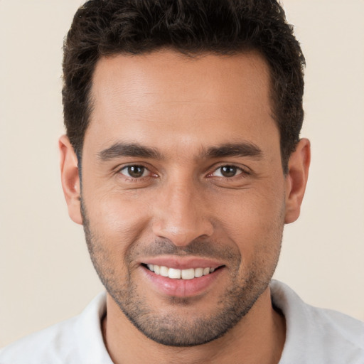 Joyful white young-adult male with short  brown hair and brown eyes