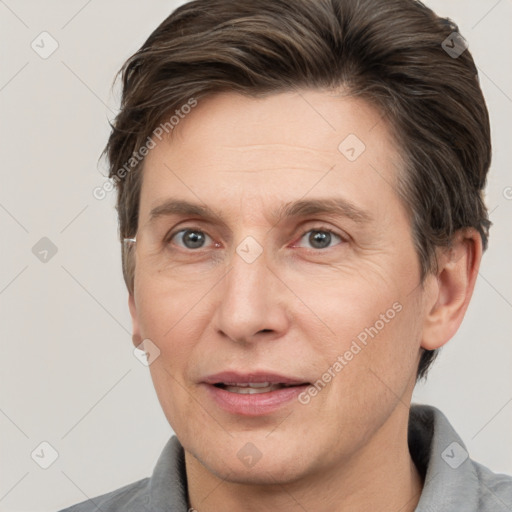 Joyful white adult male with short  brown hair and grey eyes