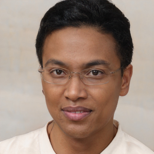 Joyful latino adult male with short  brown hair and brown eyes